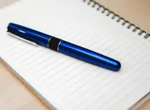 Feedback form pen desk representing 4 Best Practices for an Effective Management Feedback Survey